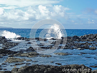 Coastline and rugged lava rocks called Dragonâ€™s Teeth and crashing waves at Makaluapuna Point near Kapalua, Maui, HI, USA Stock Photo